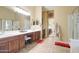 Bright bathroom features a double sink vanity, a walk-in shower, and neutral tile flooring at 708 E Dry Creek Rd, San Tan Valley, AZ 85143