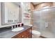 Stylish bathroom features a vanity with sink, decorative mirror, tiled shower, and toilet at 708 E Dry Creek Rd, San Tan Valley, AZ 85143