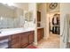 Bright bathroom features a double sink vanity and access to a large walk-in closet at 708 E Dry Creek Rd, San Tan Valley, AZ 85143