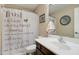 Bathroom featuring a single sink vanity and decorative shower curtain with neutral colors at 708 E Dry Creek Rd, San Tan Valley, AZ 85143