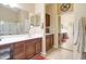 Bright bathroom features a double sink vanity and access to the walk-in closet at 708 E Dry Creek Rd, San Tan Valley, AZ 85143