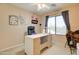 Bright bedroom featuring a sewing table, rolling desk chair, and a window providing natural light at 708 E Dry Creek Rd, San Tan Valley, AZ 85143