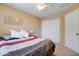 Bedroom with ceiling fan, closet, plush bedding, and neutral color scheme at 708 E Dry Creek Rd, San Tan Valley, AZ 85143