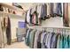 Large walk-in closet with ample storage and built in custom shelving at 708 E Dry Creek Rd, San Tan Valley, AZ 85143
