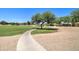 Community park with open field, walking path and mature trees, great for recreational activities and enjoying the outdoors at 708 E Dry Creek Rd, San Tan Valley, AZ 85143