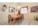 Well-lit dining area with a wooden table, six chairs, and stylish decor adding charm to the space at 708 E Dry Creek Rd, San Tan Valley, AZ 85143