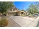 Spacious home with a two-car garage and a well-manicured desert landscape at 708 E Dry Creek Rd, San Tan Valley, AZ 85143