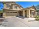 Well-kept home with a two-car garage, covered porch, and desert-style landscaping at 708 E Dry Creek Rd, San Tan Valley, AZ 85143