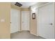 Hallway with three white doors, neutral walls and carpet flooring at 708 E Dry Creek Rd, San Tan Valley, AZ 85143