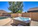 Backyard features a private hot tub with brick surround, perfect for relaxation and entertaining by the pool at 708 E Dry Creek Rd, San Tan Valley, AZ 85143