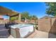 Backyard view features a private hot tub, pool and patio, perfect for relaxation and entertaining at 708 E Dry Creek Rd, San Tan Valley, AZ 85143