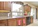 Kitchen with granite countertops, stainless steel sink, and a view of the backyard at 708 E Dry Creek Rd, San Tan Valley, AZ 85143