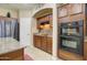 Gourmet kitchen with granite countertops, modern appliances, and dark wood cabinets at 708 E Dry Creek Rd, San Tan Valley, AZ 85143
