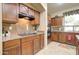 Well-equipped kitchen boasts granite counters, cooktop, wood cabinetry, and stainless appliances at 708 E Dry Creek Rd, San Tan Valley, AZ 85143