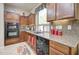 Modern kitchen featuring stainless steel appliances, granite countertops, and a cozy breakfast nook at 708 E Dry Creek Rd, San Tan Valley, AZ 85143