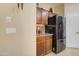 Kitchen area features stainless steel refrigerator, cabinetry, and granite countertops at 708 E Dry Creek Rd, San Tan Valley, AZ 85143