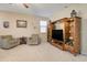 Inviting living room featuring a wooden entertainment center and comfortable seating at 708 E Dry Creek Rd, San Tan Valley, AZ 85143