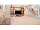 Relaxing living room with entertainment center, comfortable chair, and view of the stairway at 708 E Dry Creek Rd, San Tan Valley, AZ 85143