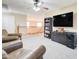 Upstairs living room area featuring a large TV, bookcase, two leather chairs and carpeted floor at 708 E Dry Creek Rd, San Tan Valley, AZ 85143