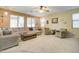 Spacious living room featuring a sectional sofa, comfortable armchairs, and large windows at 708 E Dry Creek Rd, San Tan Valley, AZ 85143
