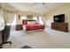 Large primary bedroom suite featuring natural light, carpeted floors and a comfortable area to relax at 708 E Dry Creek Rd, San Tan Valley, AZ 85143