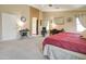 A primary bedroom with neutral colored walls, carpet, and features a ensuite bathroom at 708 E Dry Creek Rd, San Tan Valley, AZ 85143