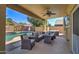 Relaxing covered patio featuring a ceiling fan, outdoor furniture set, with a pool view at 708 E Dry Creek Rd, San Tan Valley, AZ 85143