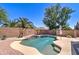 Sparkling pool with clear blue water, palm trees, and a desert landscaped backyard at 708 E Dry Creek Rd, San Tan Valley, AZ 85143