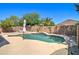 Beautiful pool area features palm trees, privacy wall, desert landscaping, and outdoor lounge at 708 E Dry Creek Rd, San Tan Valley, AZ 85143