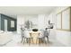 Open-concept dining area adjacent to a modern kitchen with a stylish round table and seating for six at 9532 W Pinchot Ave, Phoenix, AZ 85037
