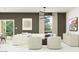 Contemporary living room with stylish furniture, neutral tones, and modern lighting at 9532 W Pinchot Ave, Phoenix, AZ 85037