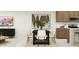 Open-concept living with dining area featuring a modern table set, perfect for entertaining at 9552 W Verde Ln, Phoenix, AZ 85037