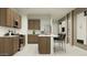 Well-designed kitchen with stainless steel appliances, center island, and stylish pendant lighting at 9552 W Verde Ln, Phoenix, AZ 85037