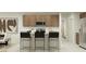 Modern kitchen features sleek cabinets, stainless steel appliances, and a convenient breakfast bar at 9552 W Verde Ln, Phoenix, AZ 85037