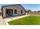 Well-maintained backyard with synthetic grass and an inviting covered patio area for outdoor relaxation at 9642 E Tesla Ave, Mesa, AZ 85212