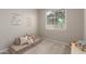 Playroom features a small couch, toys, and natural light from a window at 9642 E Tesla Ave, Mesa, AZ 85212