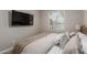Small bedroom with a bed, a window, and a wall-mounted TV at 9642 E Tesla Ave, Mesa, AZ 85212