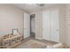 Bedroom with closet, toys, soft rug, and doorway to another room with a ceiling fan at 9642 E Tesla Ave, Mesa, AZ 85212