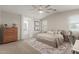 Cozy bedroom with neutral tones, natural light, and a view into the ensuite bathroom at 9642 E Tesla Ave, Mesa, AZ 85212