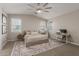A bright bedroom with neutral tones, a ceiling fan, and a dedicated workspace at 9642 E Tesla Ave, Mesa, AZ 85212