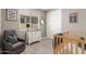 Bedroom with crib, gray chair, dresser with decor, round mirror, and natural light at 9642 E Tesla Ave, Mesa, AZ 85212