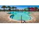 Large community pool with vibrant water slides, fountain feature, and comfortable lounge chairs at 9642 E Tesla Ave, Mesa, AZ 85212