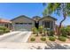 Charming single-story home featuring a two car garage and desert landscaping in the front yard at 9642 E Tesla Ave, Mesa, AZ 85212