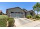 Charming single-story home featuring a two car garage and desert landscaping in the front yard at 9642 E Tesla Ave, Mesa, AZ 85212