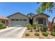 Charming single-story home featuring a two car garage and desert landscaping in the front yard at 9642 E Tesla Ave, Mesa, AZ 85212