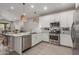 Bright kitchen featuring stainless steel appliances, white cabinets, and a subway tile backsplash at 9642 E Tesla Ave, Mesa, AZ 85212