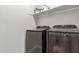 Laundry room featuring a modern washer and dryer and a shelf for storage at 9642 E Tesla Ave, Mesa, AZ 85212