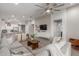 Open-concept living room with a large sectional sofa, television, and kitchen view at 9642 E Tesla Ave, Mesa, AZ 85212