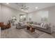 Inviting living room with a large sectional sofa and a view into the kitchen at 9642 E Tesla Ave, Mesa, AZ 85212
