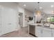 Open concept kitchen flows to the dining and living room with lots of natural light at 9642 E Tesla Ave, Mesa, AZ 85212